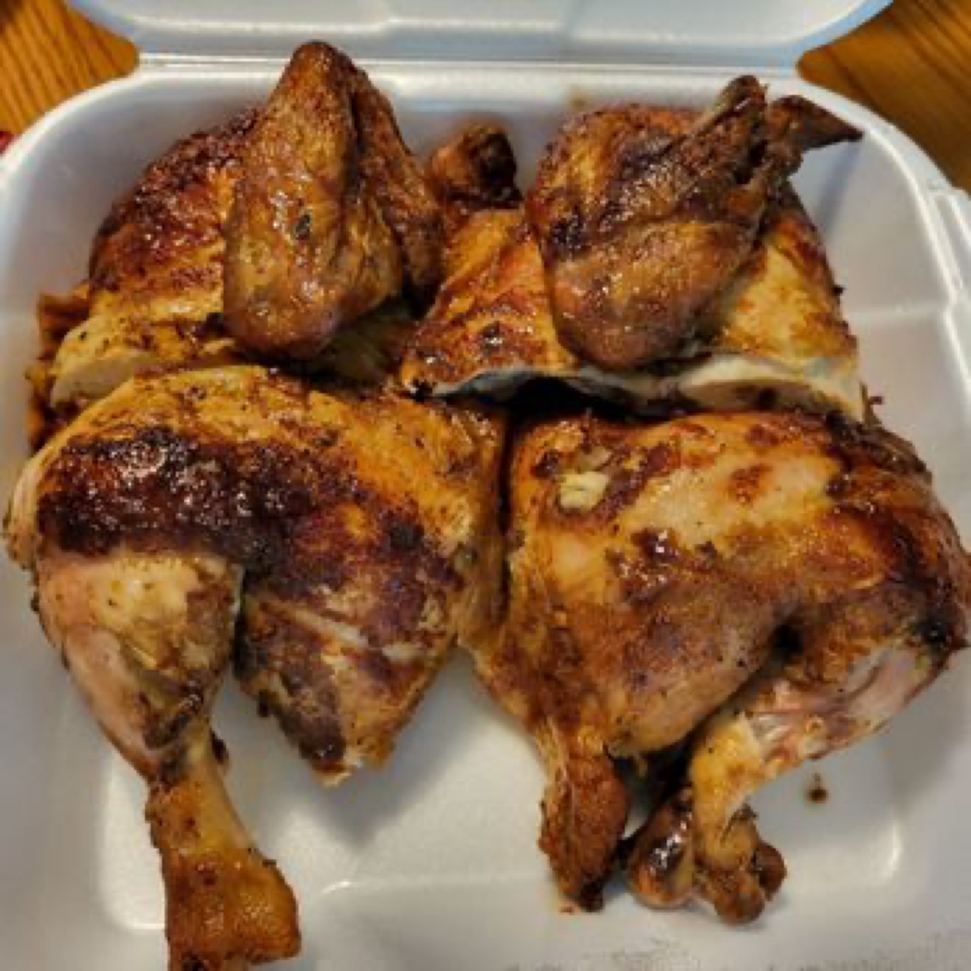 Half rotisserie chicken in a takeout container